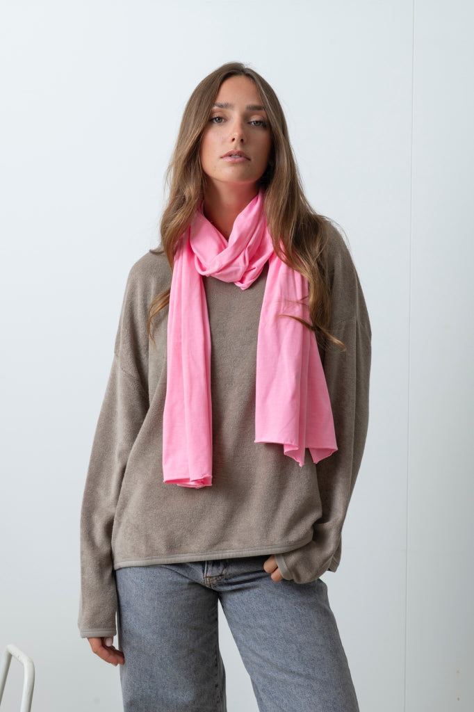 Chèche Iseult rose malabar Suny en coton bio certifié GOTS, porté autour du cou avec un sweat Suny